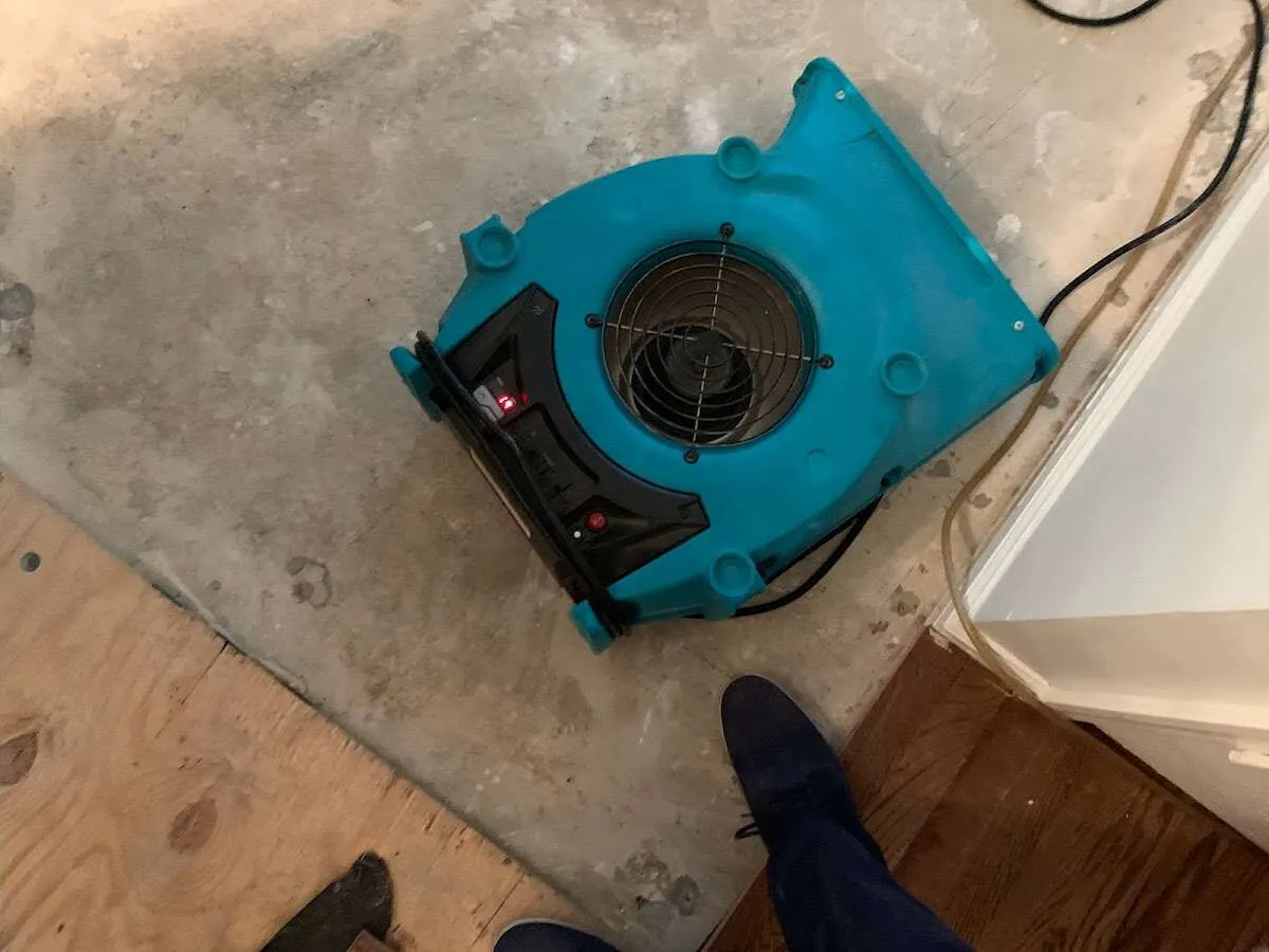 Air mover drying subfloor during Leak Detection & Repair in Wyoming